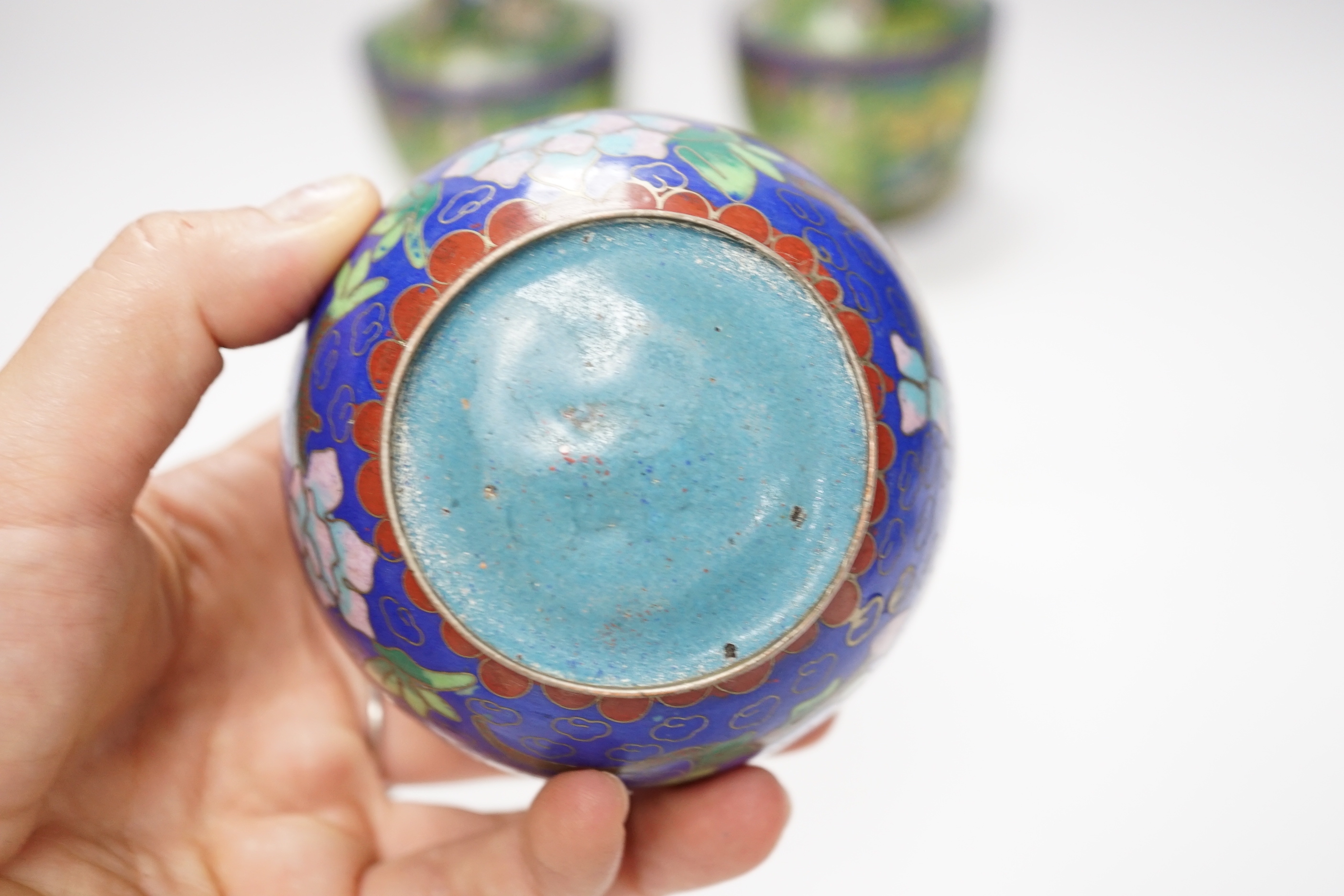 A pair of Chinese cloisonné enamel vases and a box and cover, vases 14cm high